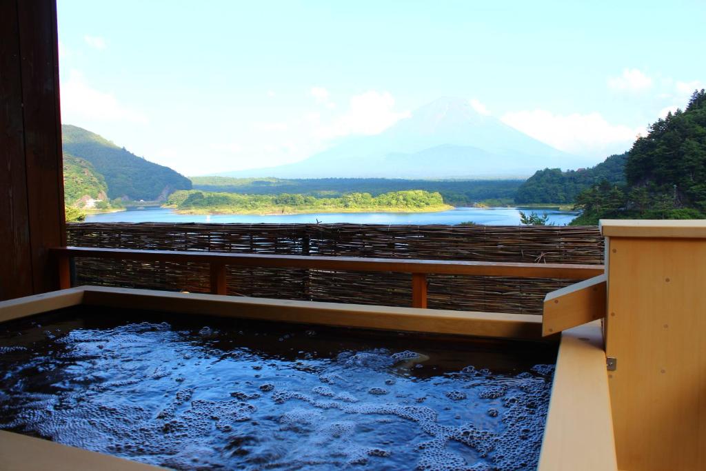 a pool of water with a view of a mountain at Yamadaya Hotel in Fujikawaguchiko