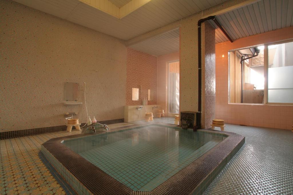 a large bathroom with a large tub in a room at Yamadaya Hotel in Fujikawaguchiko