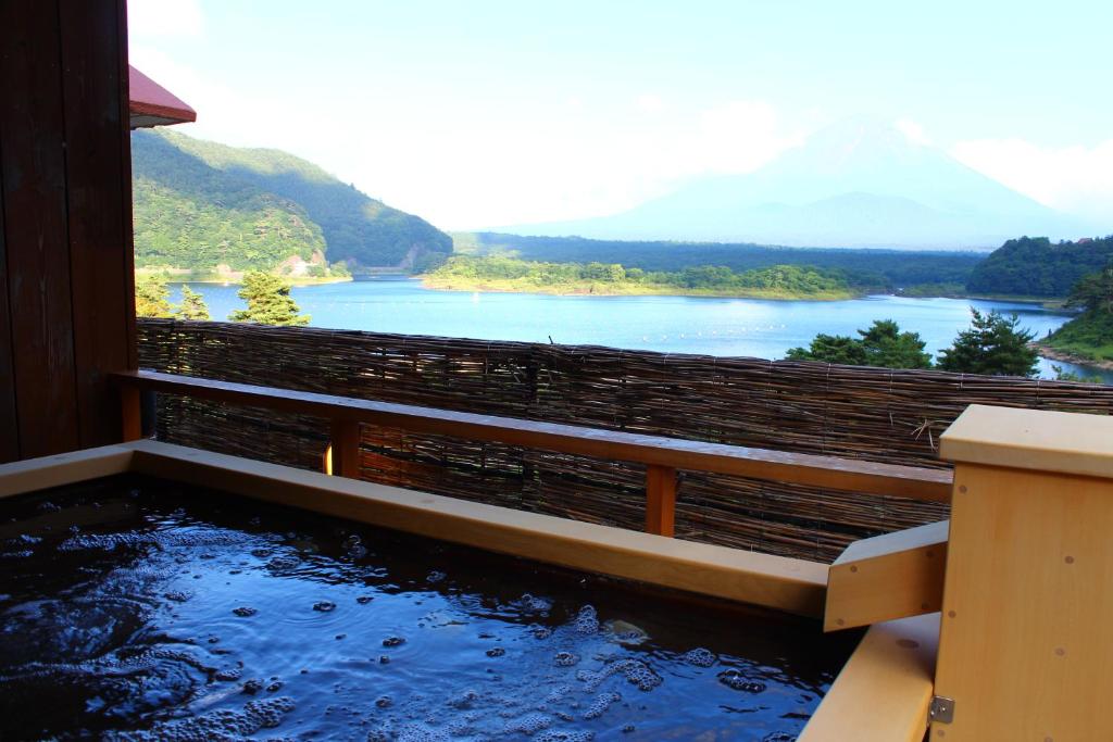 a pool of water with a view of a lake at Yamadaya Hotel in Fujikawaguchiko