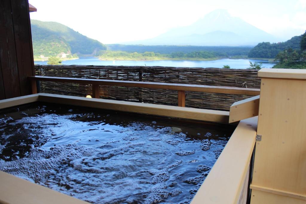 a pool of water with a view of a mountain at Yamadaya Hotel in Fujikawaguchiko