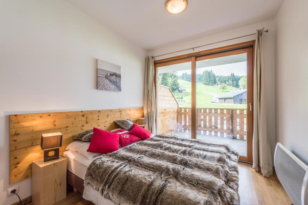 Postel nebo postele na pokoji v ubytování L'Eden Ski aux Pieds