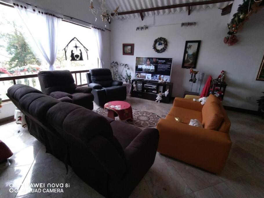 sala de estar con sofá y silla en Casa Grande Guateque, en Guateque