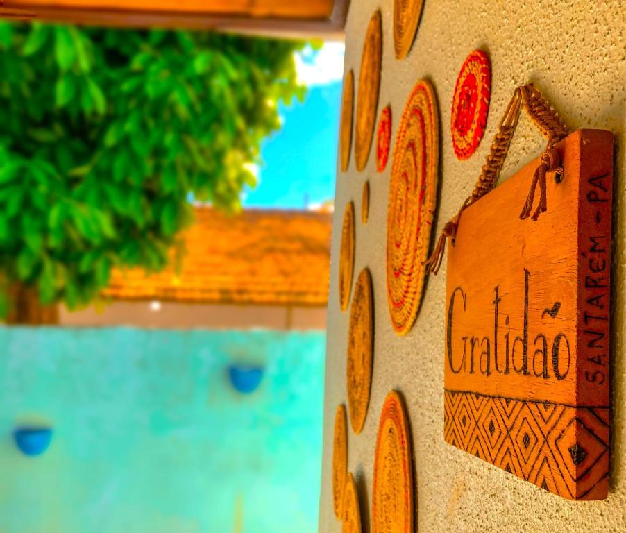 a close up of a wooden sign on a wall at Pousada Casa do Ivo Alter do Chão in Alter do Chao