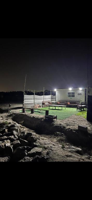 a group of benches in a field at night at كرفانات الدار in Ras al Khaimah