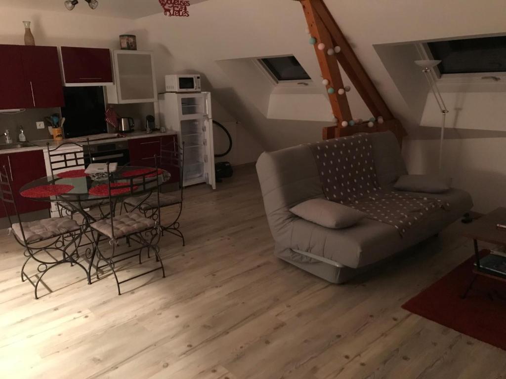 uma sala de estar com um sofá e uma mesa em Gîte "Le Drouzet" em Le Chazal
