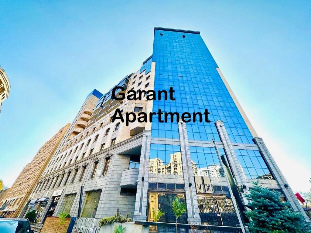 a building with a sign on the side of it at Apartments by GR Yerevan in the city centre in Yerevan