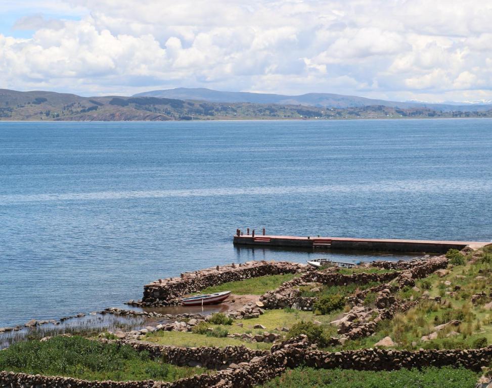 a view of a large body of water with a pier at BLUE SKY Amantani Lodge in Ocosuyo