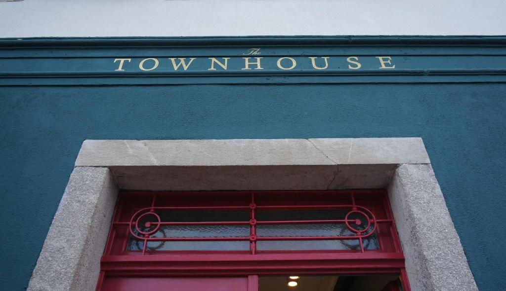 a green building with a window with the words townhouse at The Townhouse in Udine