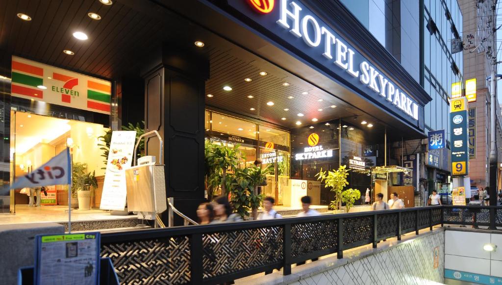 a restaurant with people sitting in front of a store at Hotel Skypark Myeongdong 3 in Seoul