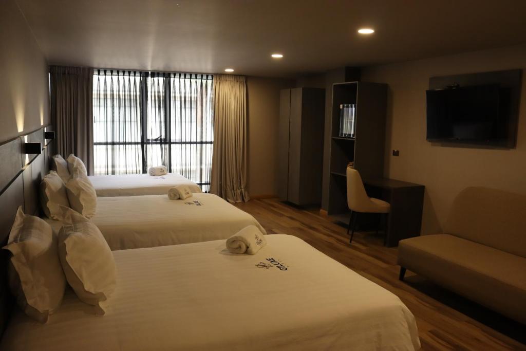Postel nebo postele na pokoji v ubytování Giluxe Hotel