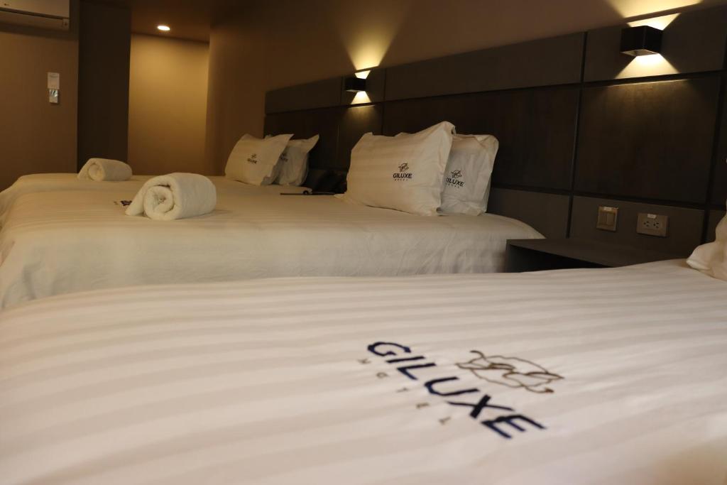 Postel nebo postele na pokoji v ubytování Giluxe Hotel