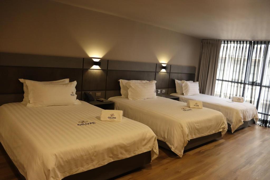 Postel nebo postele na pokoji v ubytování Giluxe Hotel