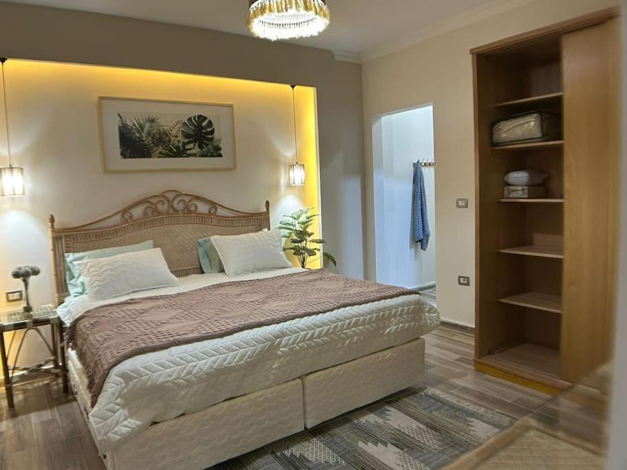 a bedroom with a large bed in a room at New furnished apartment in Cairo