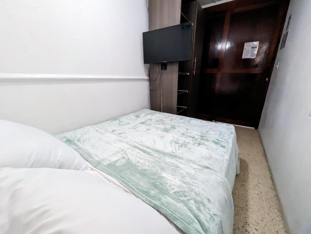 Postel nebo postele na pokoji v ubytování Hostal Yoha