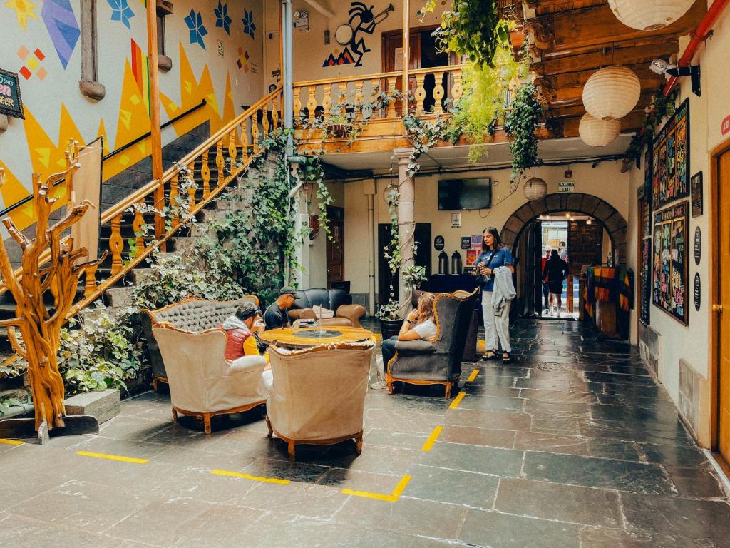 a group of people sitting at a table in a building at Viajero Cusco Hostel in Cusco