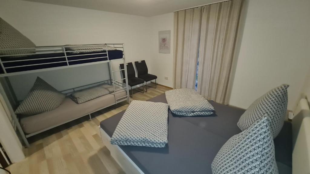 a living room with a table and a bed at Apartament Berghof in Bayerischen Wald in Sankt Englmar