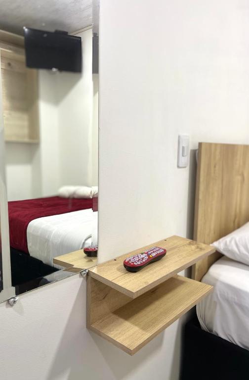 Postel nebo postele na pokoji v ubytování Hotel Urban Center Bogota