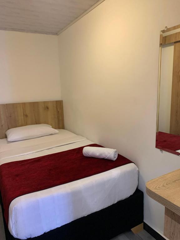 Postel nebo postele na pokoji v ubytování Hotel Urban Center Bogota