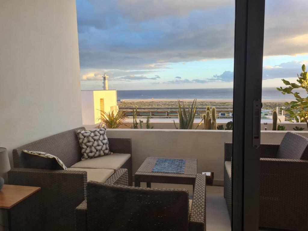 a balcony with a couch and a view of the ocean at Apartment Casa M in Morro Jable in Morro del Jable