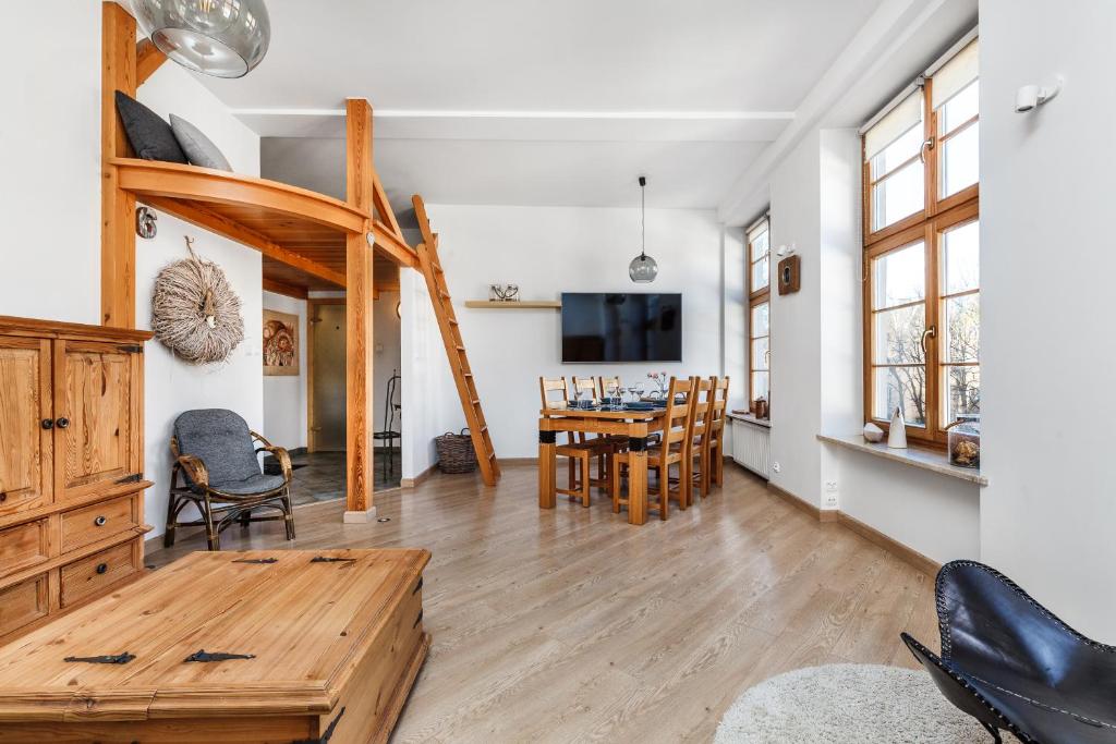 Hotel Old Town Piwna, a living room and dining room with a table and chairs at Old Town Piwna in Gdańsk