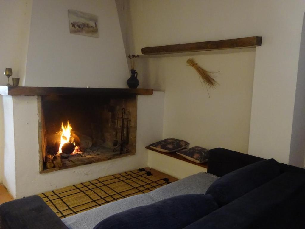 a living room with a fireplace and a couch at New Village in Vila Nova da Baronia