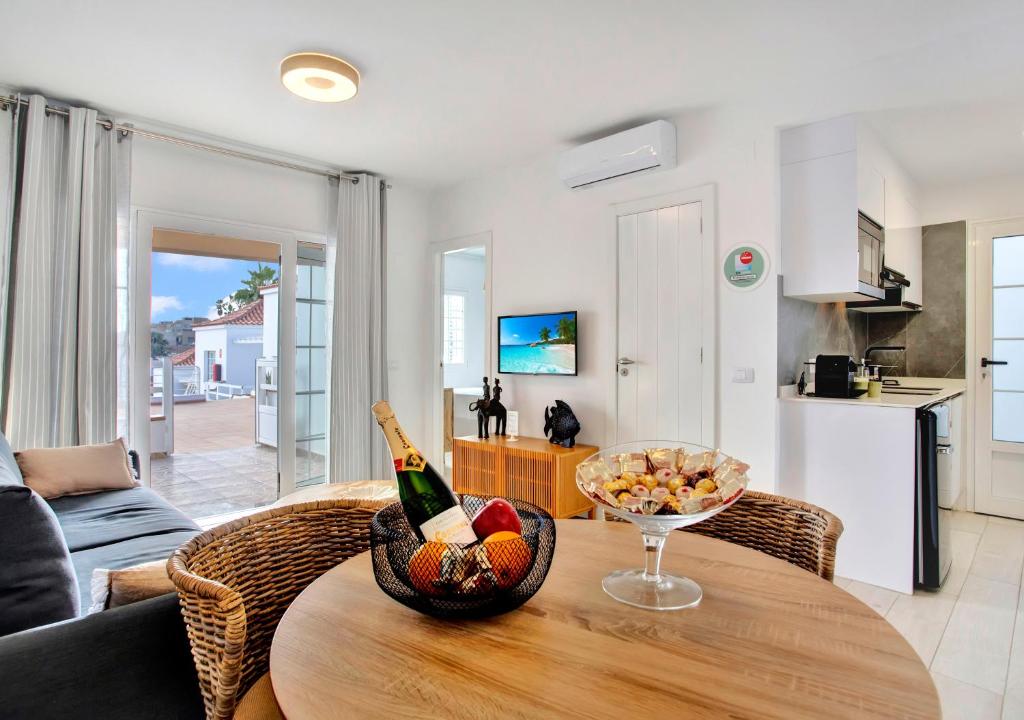 a living room with a table with a bowl of fruit on it at Silvic Serenada in Corralejo