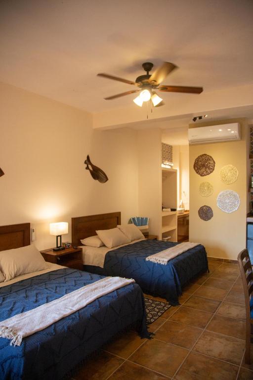 ein Schlafzimmer mit zwei Betten und einem Deckenventilator in der Unterkunft Estancia 104 in La Paz