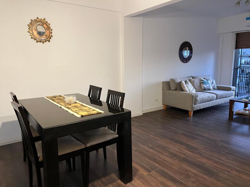 - une salle à manger avec une table, des chaises et un canapé dans l'établissement Tu departamento en Vicente López, à Vicente López
