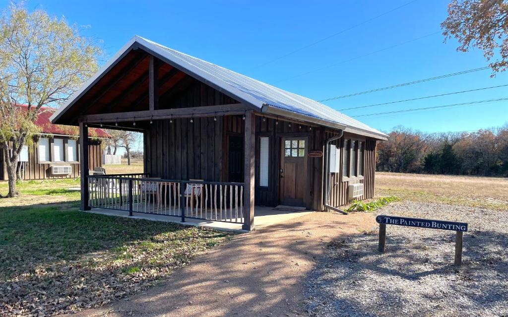 a small building with a sign in front of it at Painted Bunting Cabin 15 MIN to MagnoliaBaylor in Elm Mott