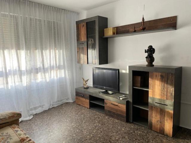 a living room with a flat screen tv on a entertainment center at Apartamento Diagonal in Nules