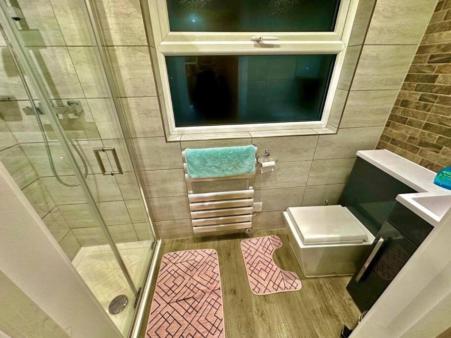 a small bathroom with a shower and a sink at Studio near Heathrow in West Drayton