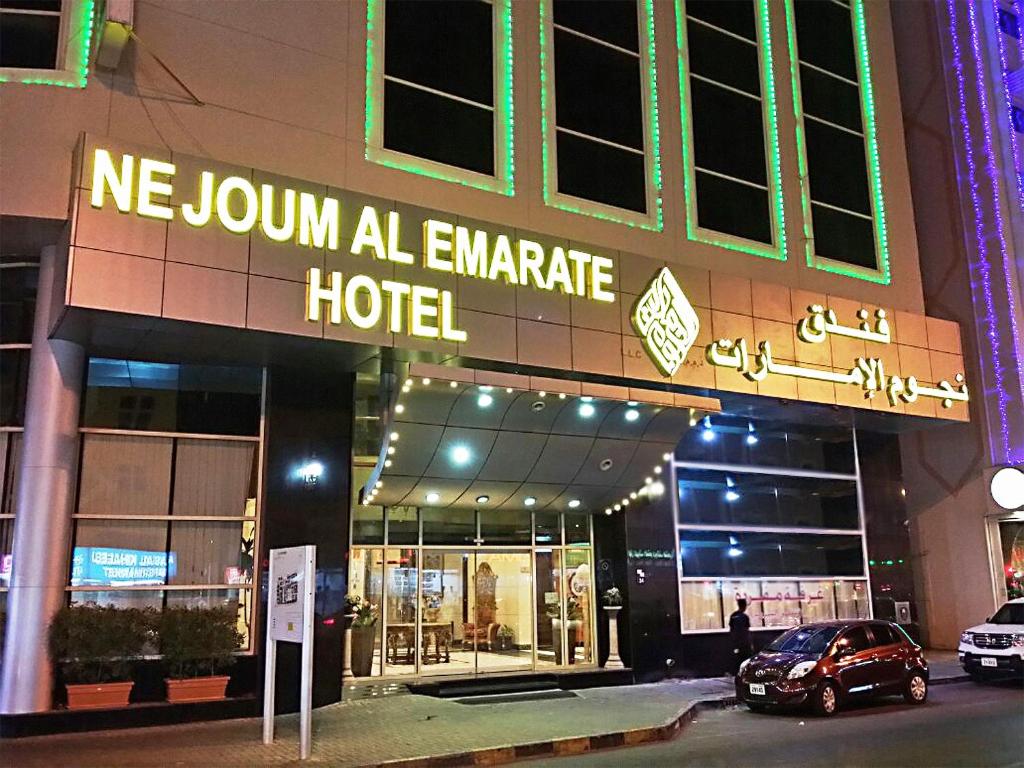 a hotel with a sign on the front of it at Nejoum Al Emarat in Sharjah