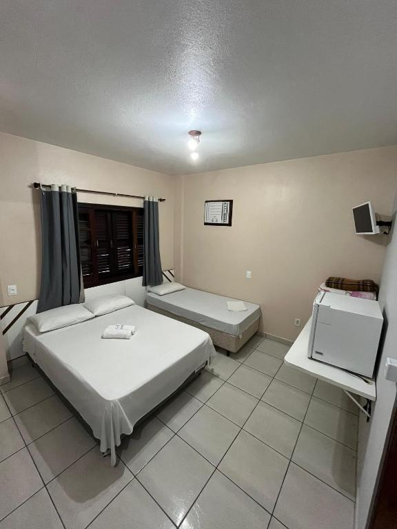Cama ou camas em um quarto em Hotel D'Luz