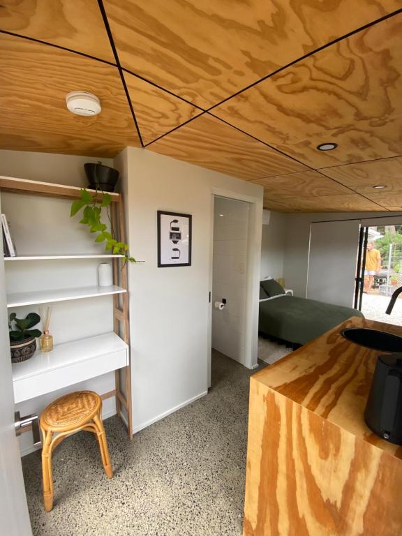 a room with a bed and a wooden ceiling at Central Gem in Dunsborough