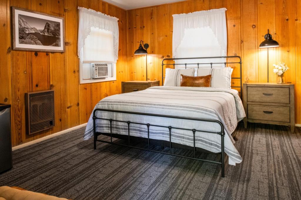 a bedroom with a bed and a tv in a room at Inn at Sugar Pine Ranch in Groveland