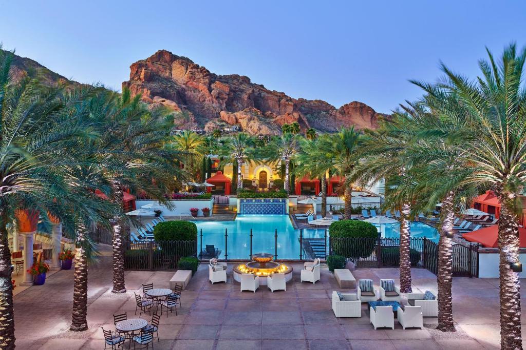a resort with palm trees and a swimming pool at Omni Scottsdale Resort & Spa at Montelucia in Scottsdale