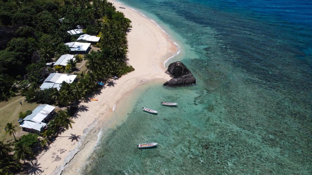 an aerial view of a beach with boats in the water at Manu Getaway Guesthouse in Namara