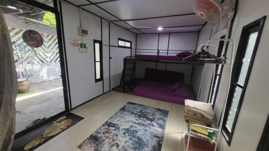 a small room with a purple bunk bed in it at THE K KABIN in Pekan