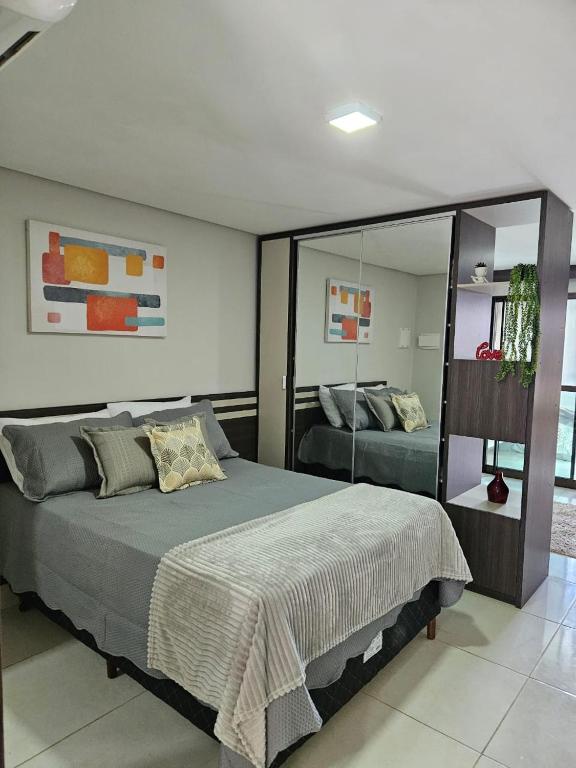 a bedroom with a bed and a large mirror at Alto Da Serra Villas in Bananeiras