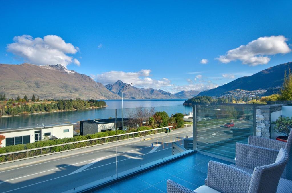 a balcony with a view of a lake and mountains at Pure Retreat Lake View in Queenstown