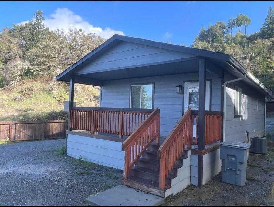 a small blue house with a large deck at New, Fun-Size Benbow House! in Garberville