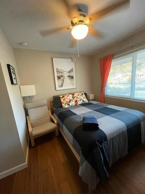 a bedroom with a bed and a ceiling fan at Quaint Guest Room Close to Siesta Key in Sarasota