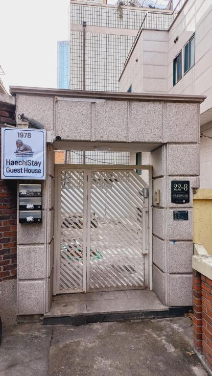 a garage door with a gate in front of a building at Haechi Stay GuestHouse - For foreigners only in Seoul