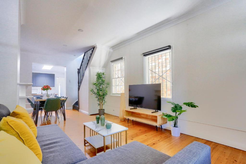 a living room with a couch and a tv at 3 Bedroom House Chippendale Near the Center 2 E-Bikes Included in Sydney
