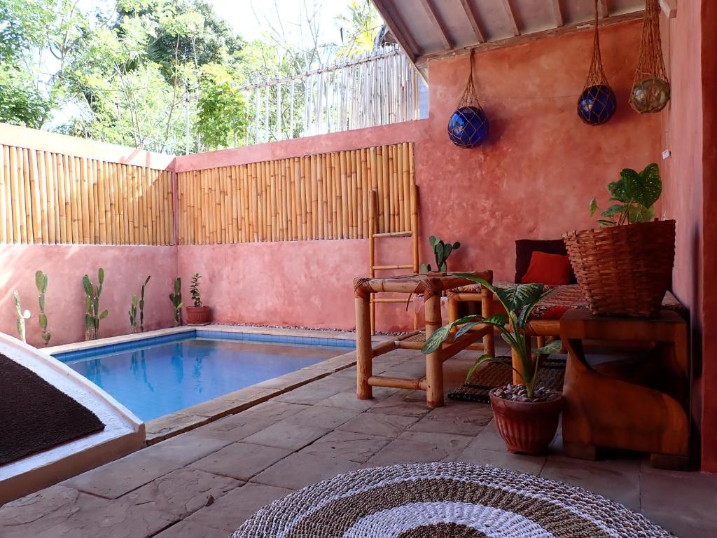 a patio with a swimming pool and a table at Villa Sea La Vie Private pool in Gili Meno