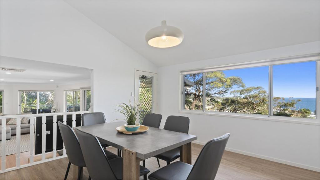 a dining room with a table and chairs at New With A View Accom Holidays in Copacabana