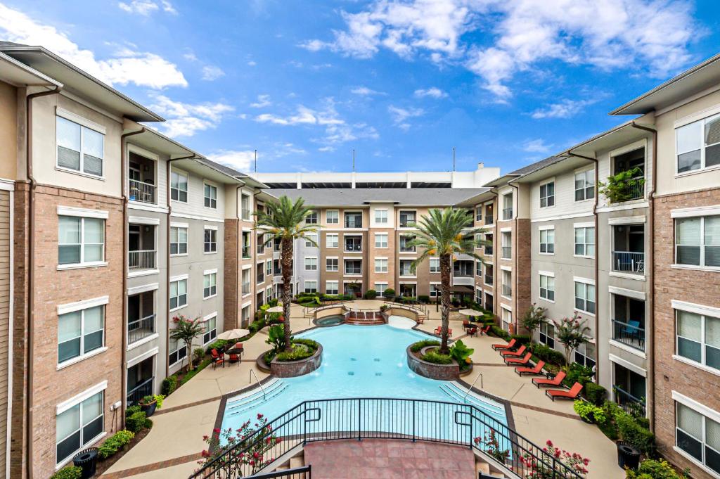 an apartment courtyard with a swimming pool and buildings at Pool View 1-bedroom Unit in Houston