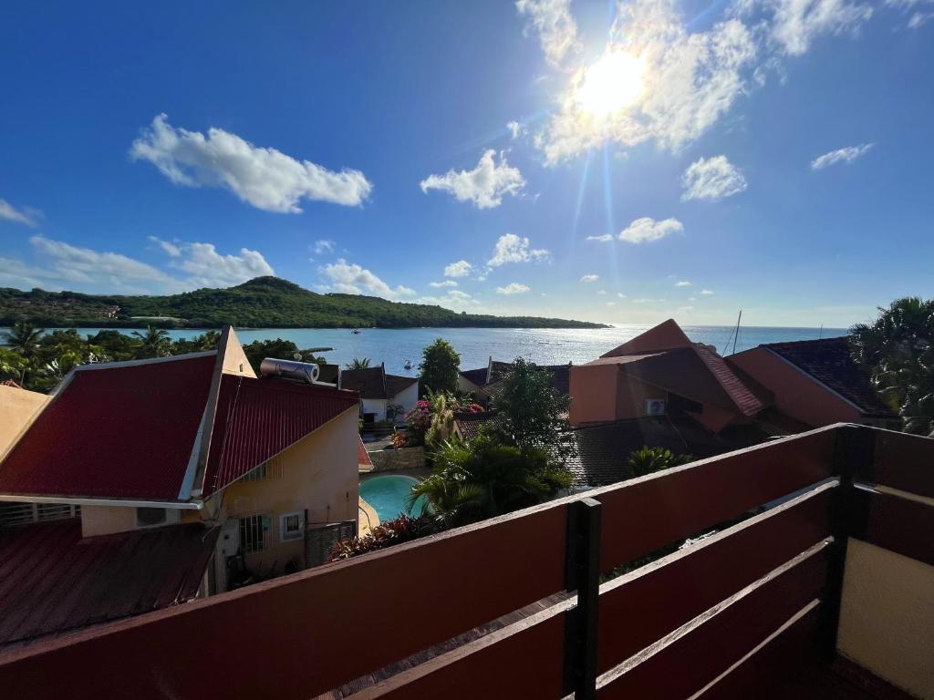 a view of the water from the balcony of a house at Villa Astéria in Le Diamant