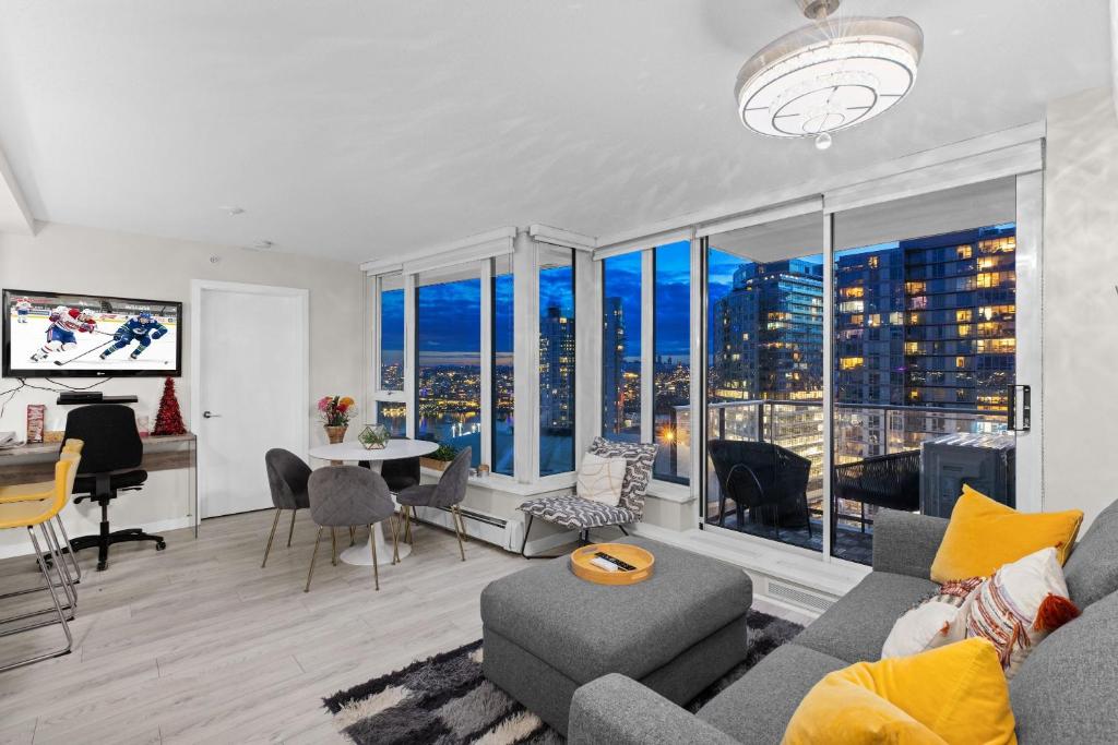 an apartment living room with a view of a city at Beautiful Bright Modern Condo with Water view and AC in DT Vancouver 2BR,3BD,2BT sleeps 6 guests Free parking Netflix Included in Vancouver