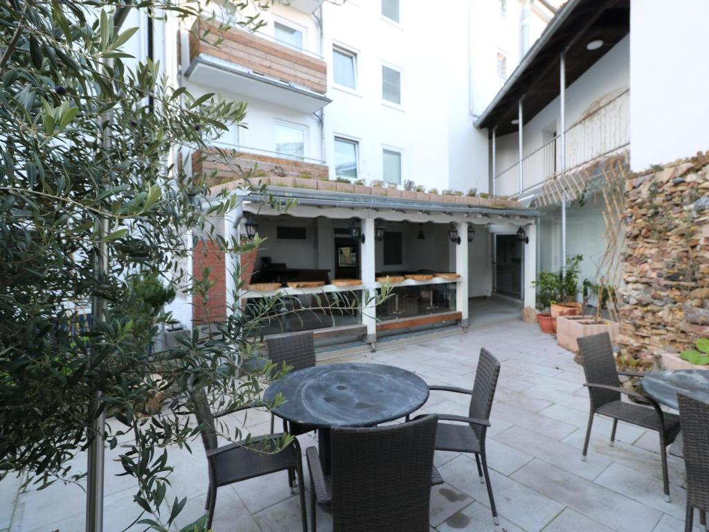 an outdoor patio with a table and chairs at Property in Essen in Essen